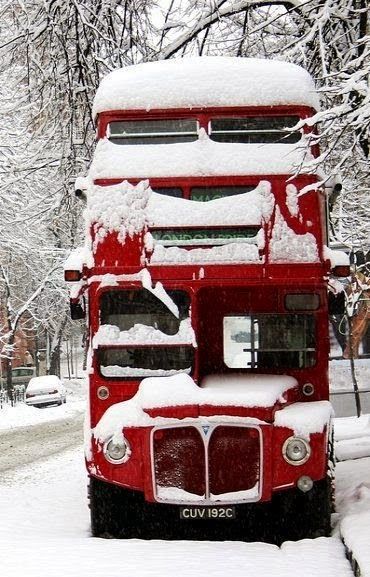 Snow covered red double-decker bus ~ England