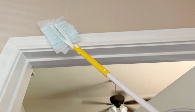 dusting top of door frame