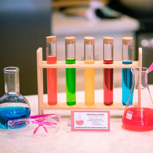 Colorful beakers on table.
