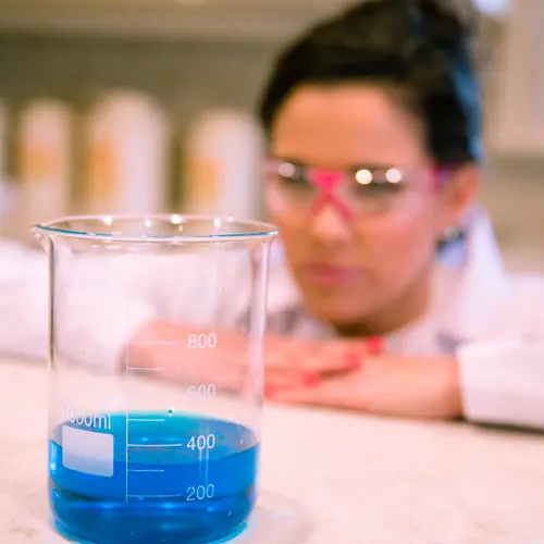 Closeup shot of blue liquid in beaker.