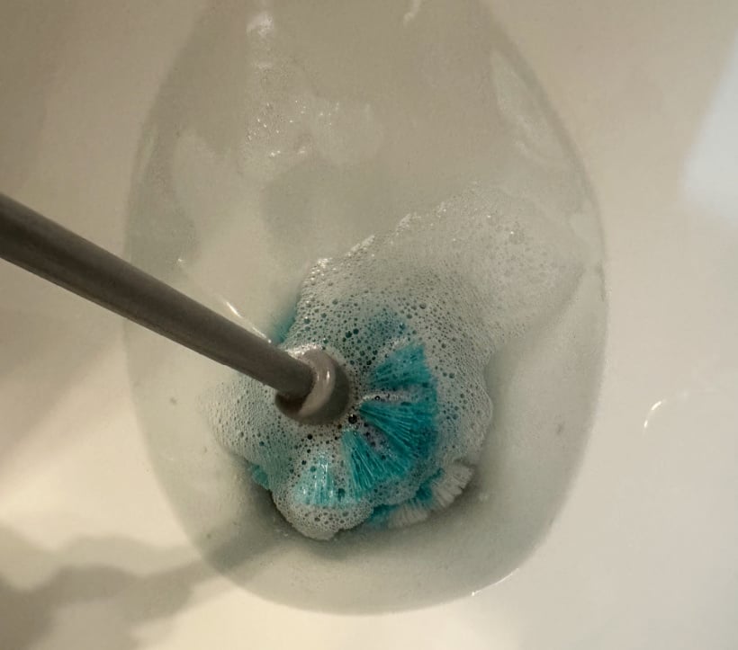 cleaning the toilet with homemade cleaning powder