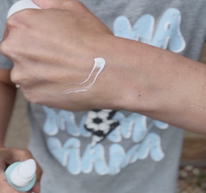 a chemist using Hydrating Mineral Sunscreen 